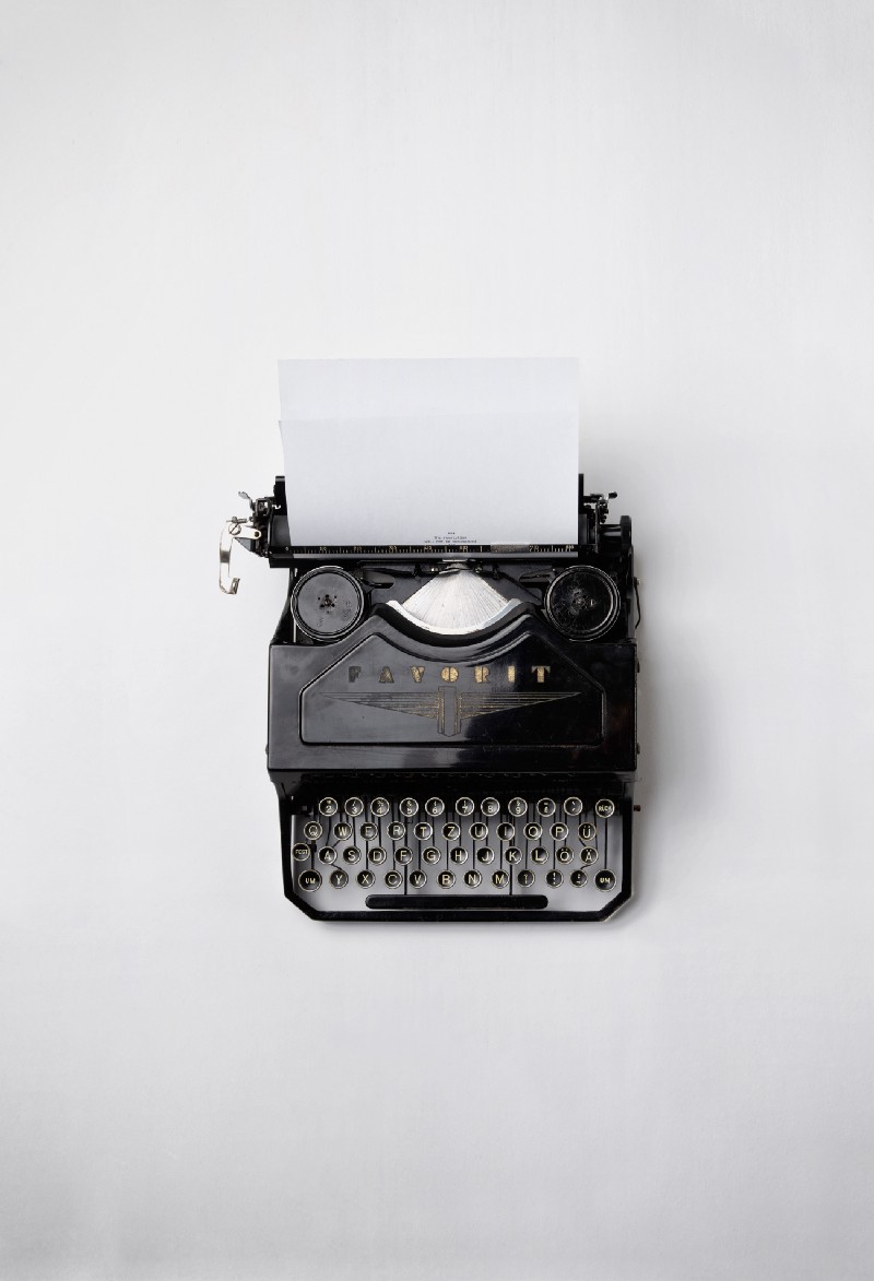 “A vintage analogue typewriter with a white plain paper” by Florian Klauer